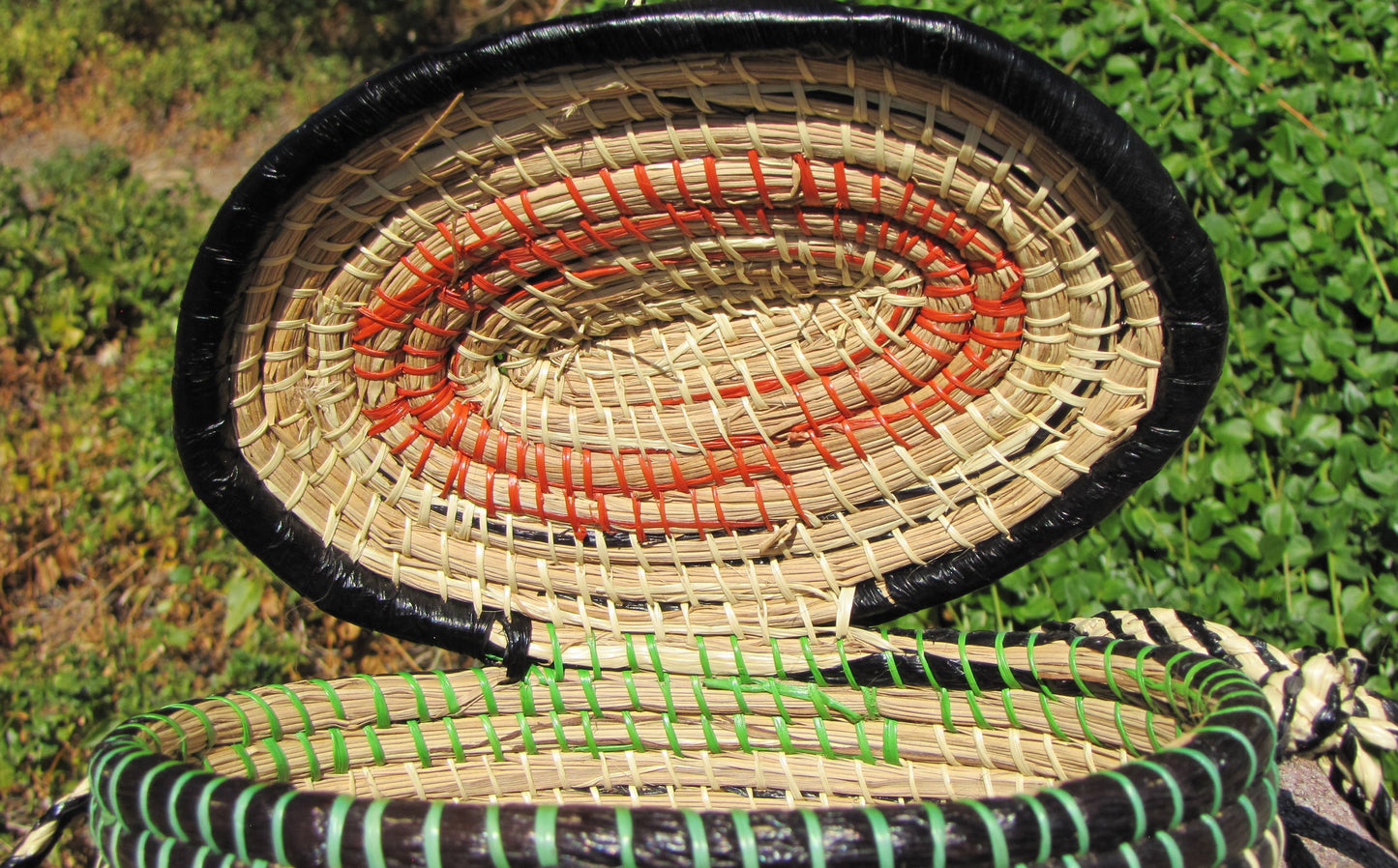 Hand weaved collection basket; closable with strap for easy carrying