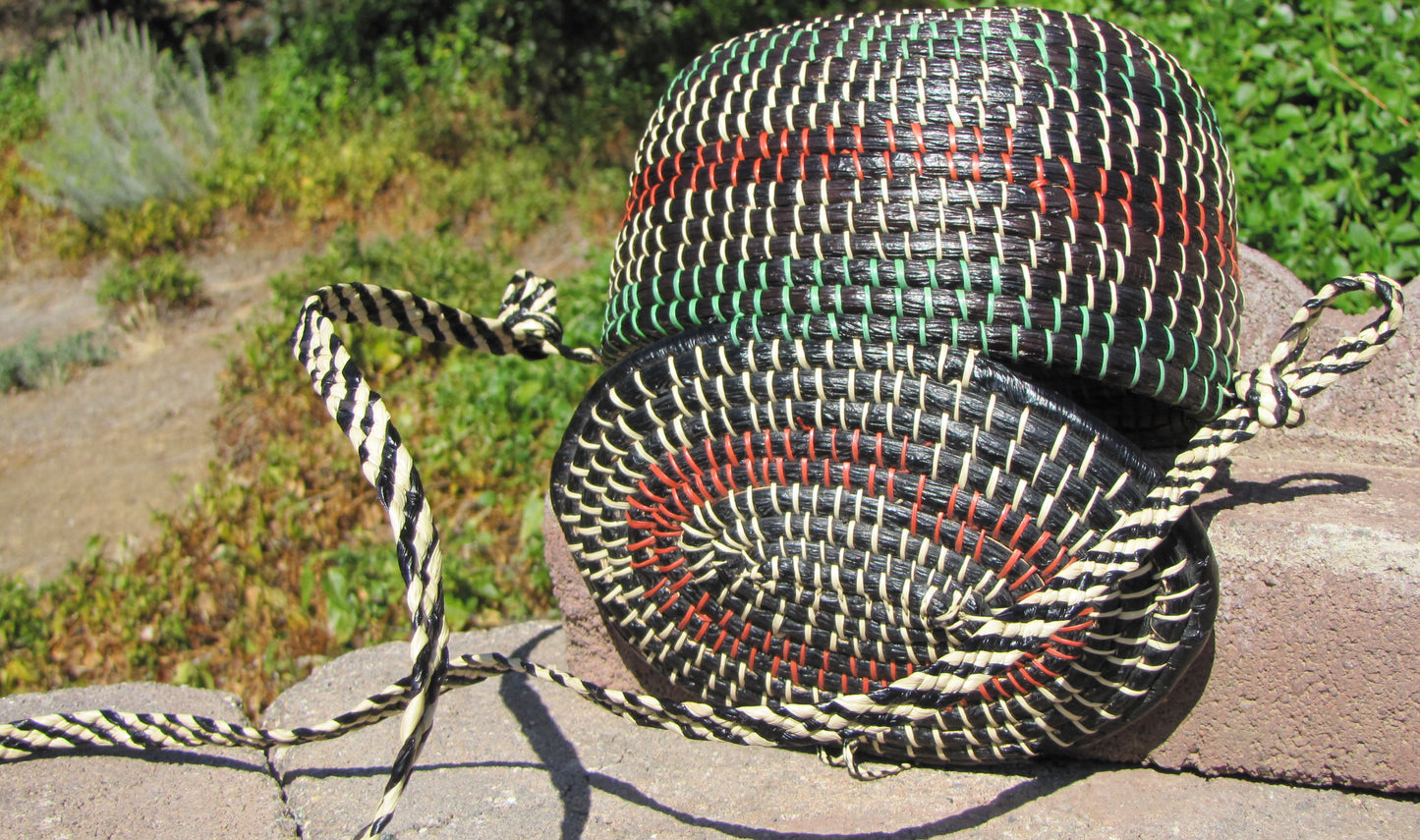 Hand weaved collection basket; closable with strap for easy carrying